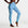 Blue patterned swim leggings worn by a person on a white background