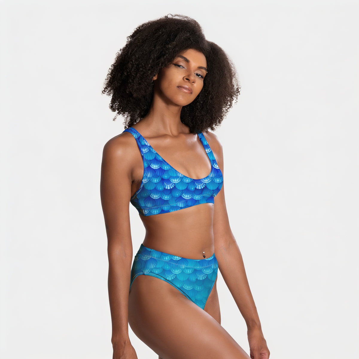 Woman wearing a blue patterned bikini against a white background